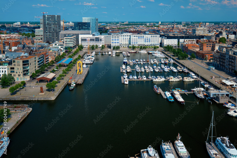 Yachts at the oldest harbor district of Antwerp city called Eilandje. Used as a yacht marina with waterfront promenade, Antwerp Province, Belgium