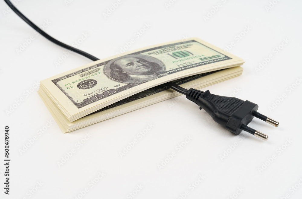 Electric plug and dollars on the table. Electric plug and dollars on the table.