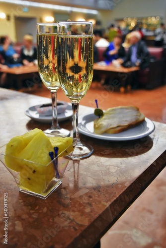 Two glasses of champagne and pineapple pieses photo