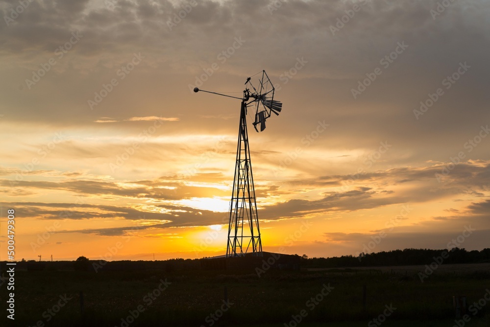 farm wind mill at sunset