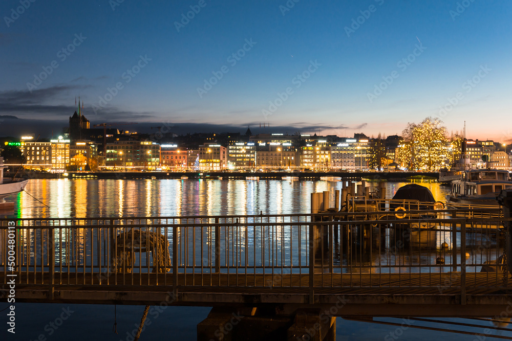 Geneve. Switzerland - December 30, 2021: Sunset over Geneva. Embankment of leman River