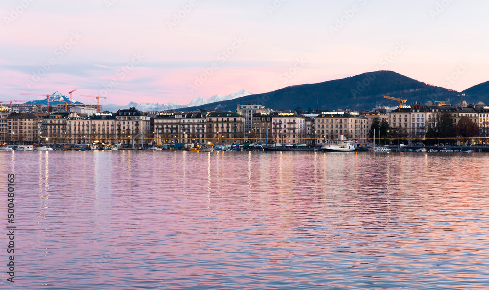 Geneve. Switzerland - December 30, 2021: View of the evening embankment of Geneva on Lake leman