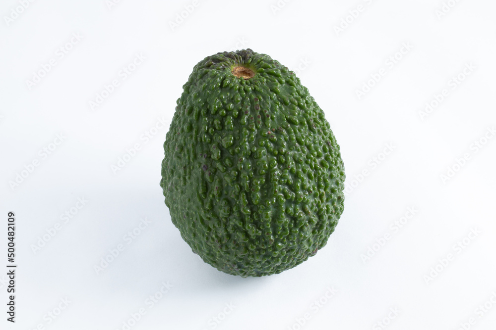 Obraz premium Nutritious and healthy avocado, whole and raw, with wrinkled and green skin