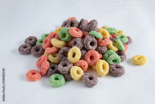Portion of colorful fruit breakfast cereal, without milk, on white background
