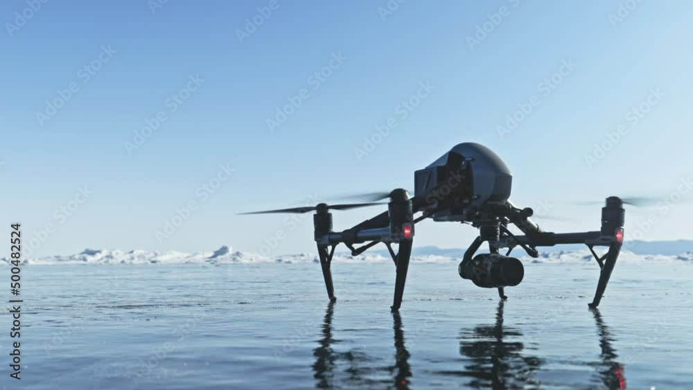 Professional drone takes off into the air from the ice