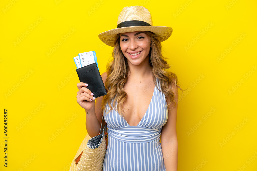 Young woman goes on vacation to the beach isolated on yellow background smiling a lot Young woman goes on vacation to the beach isolated on yellow background smiling a lot