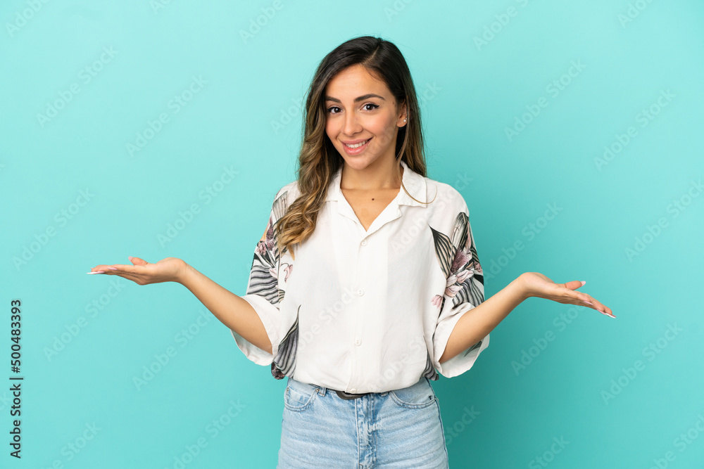 Young woman over isolated blue background having doubts Young woman over isolated blue background having doubts