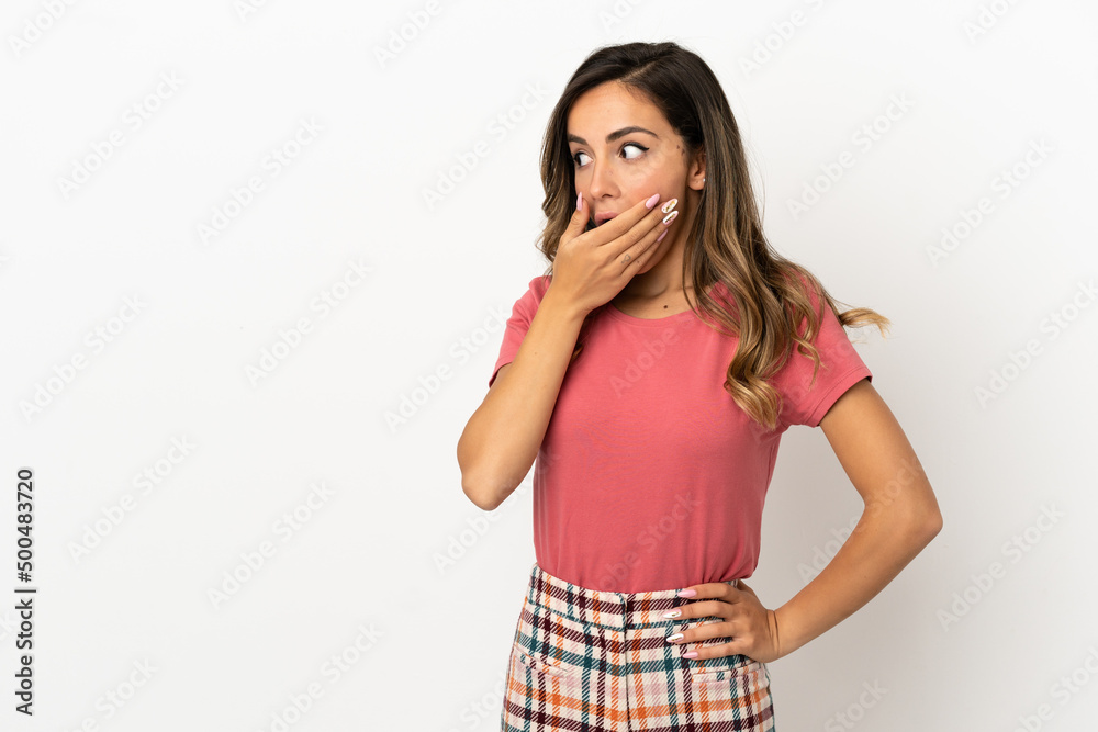 Young woman over isolated background doing surprise gesture while looking to the side Young woman over isolated background doing surprise gesture while looking to the side