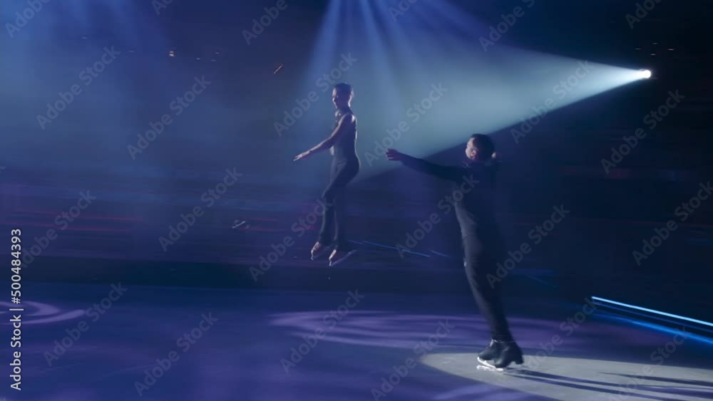 Throw phase structure in figure skating,run-up, preparation and execution of female partner repulsion, her flight in air in grouping, woman ungrouping, landing and graceful exit of both.Slow motion.
