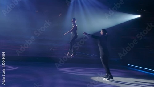 Throw phase structure in figure skating,run-up, preparation and execution of female partner repulsion, her flight in air in grouping, woman ungrouping, landing and graceful exit of both.Slow motion.