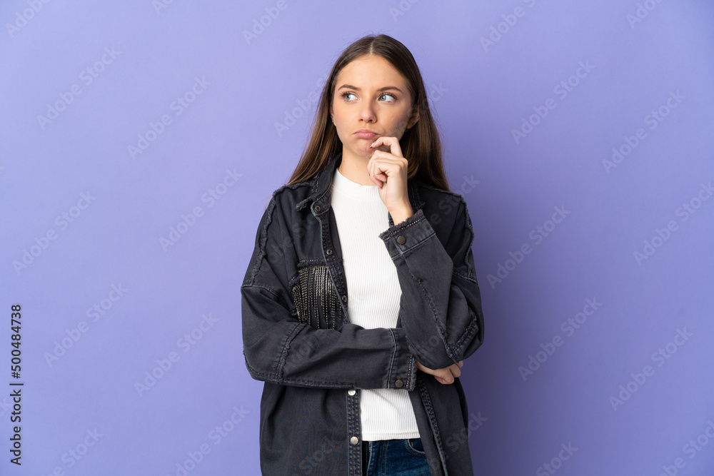 Young Lithuanian woman isolated on purple background having doubts and thinking Young Lithuanian woman isolated on purple background having doubts and thinking