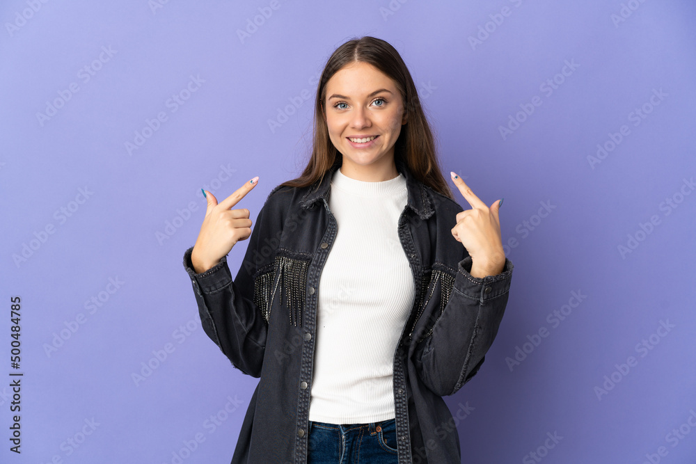 Young Lithuanian woman isolated on purple background giving a thumbs up gesture Young Lithuanian woman isolated on purple background giving a thumbs up gesture