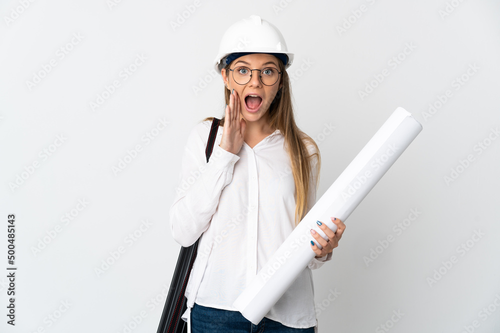 Young Lithuanian architect woman with helmet and holding blueprints isolated on white background with surprise and shocked facial expression Young Lithuanian architect woman with helmet and holding blueprints isolated on white background with surprise and shocked facial expression