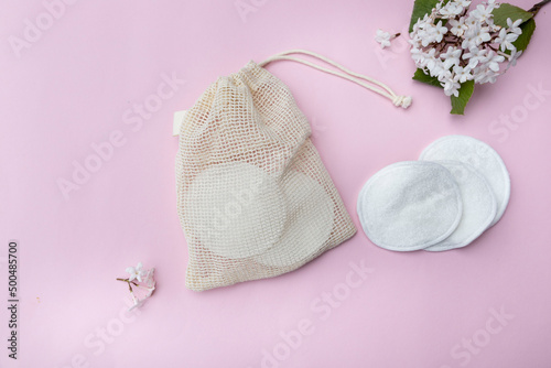 Reusable cotton make-up remover wipes in a cloth pouch. Reusable cotton pads with flowers. Zero waste concept.