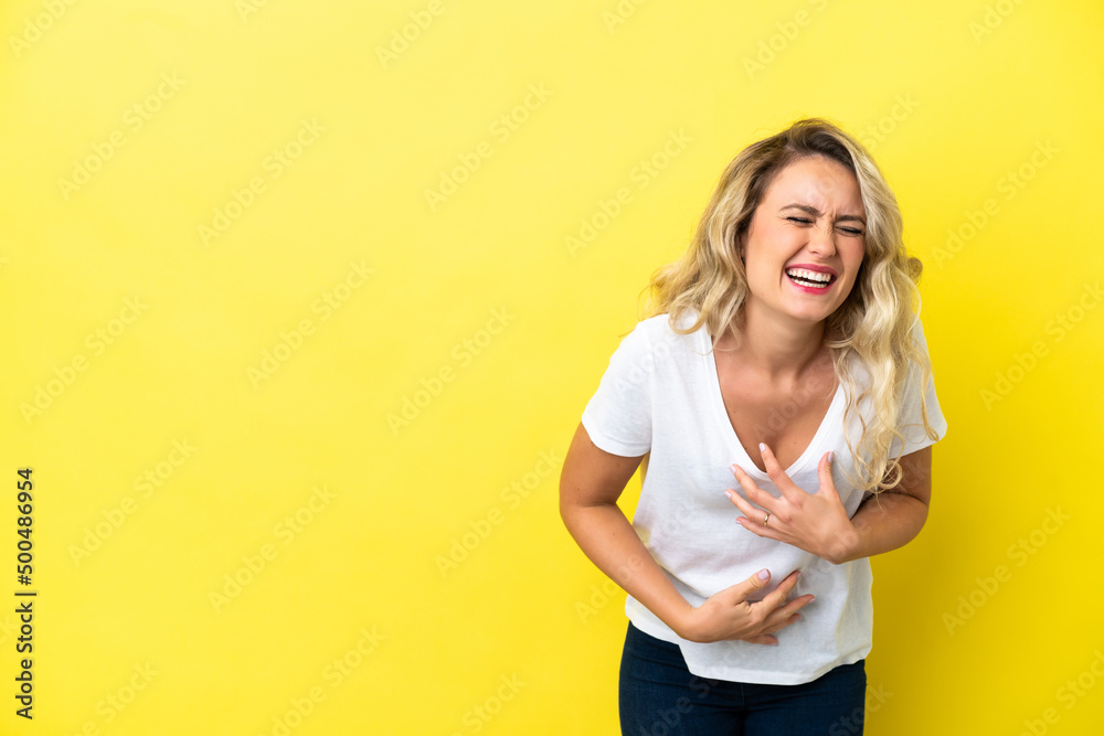 Young Brazilian woman isolated on yellow background smiling a lot Young Brazilian woman isolated on yellow background smiling a lot