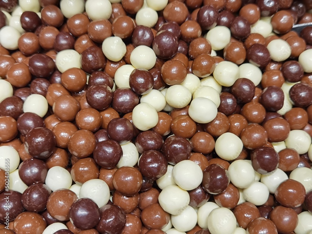 Hazelnuts coated in white and dark chocolate Hazelnuts coated in white and dark chocolate