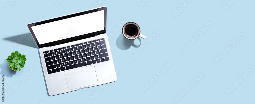 Laptop computer with a coffee cup from above Laptop computer with a coffee cup from above