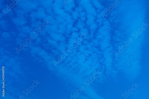 Intense blue cold chemtrail sky, abstract blue background