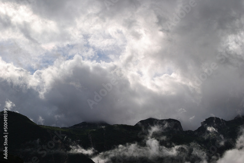 Rugged Hillside with Low Clouds