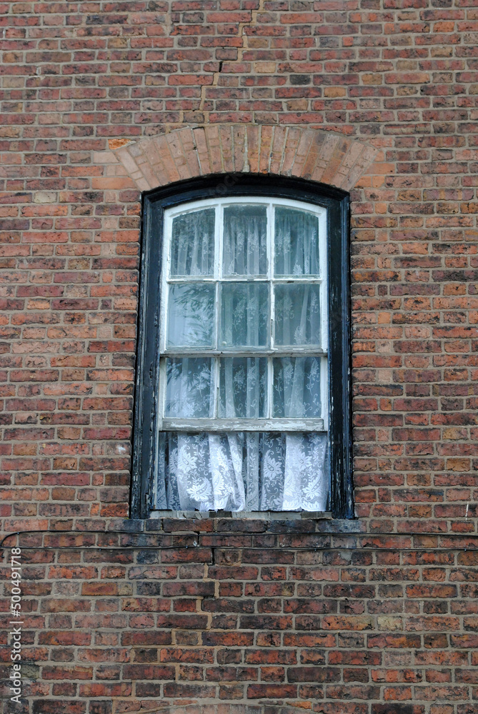 Old Arched Wooden Window in Brick Wall  