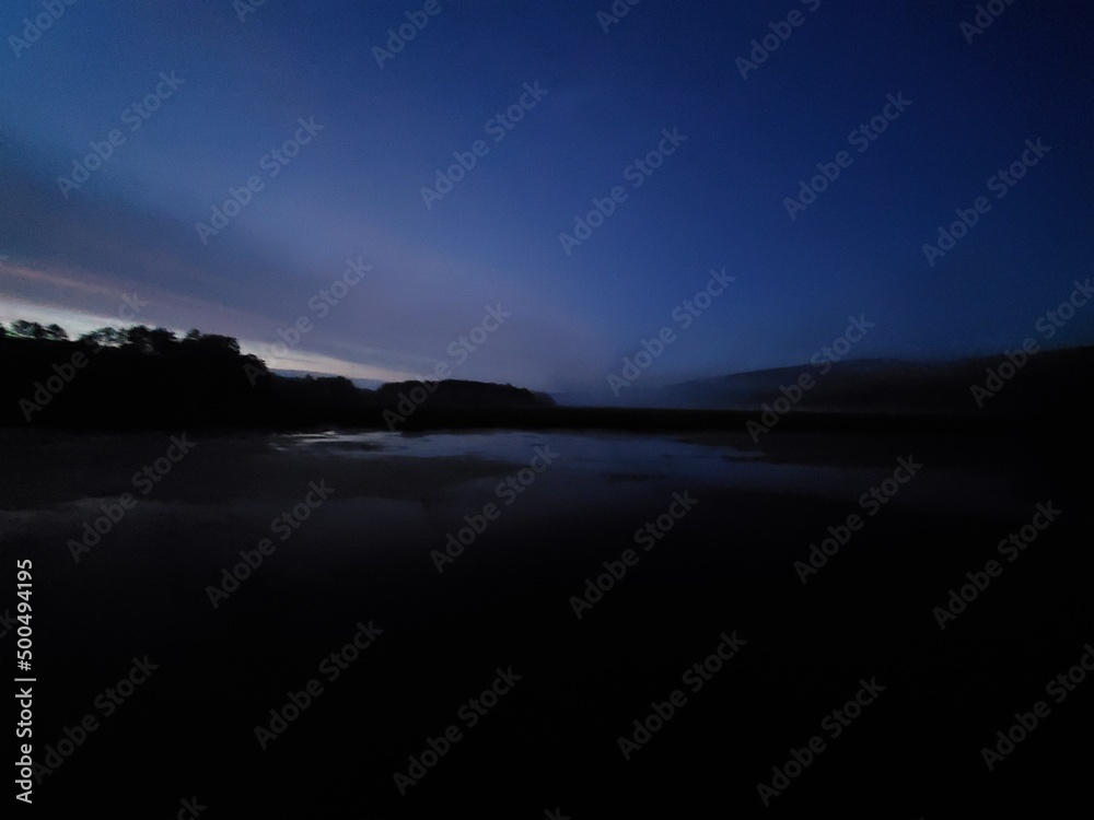 Fototapeta premium sunset over wetlands and mountain ridge
