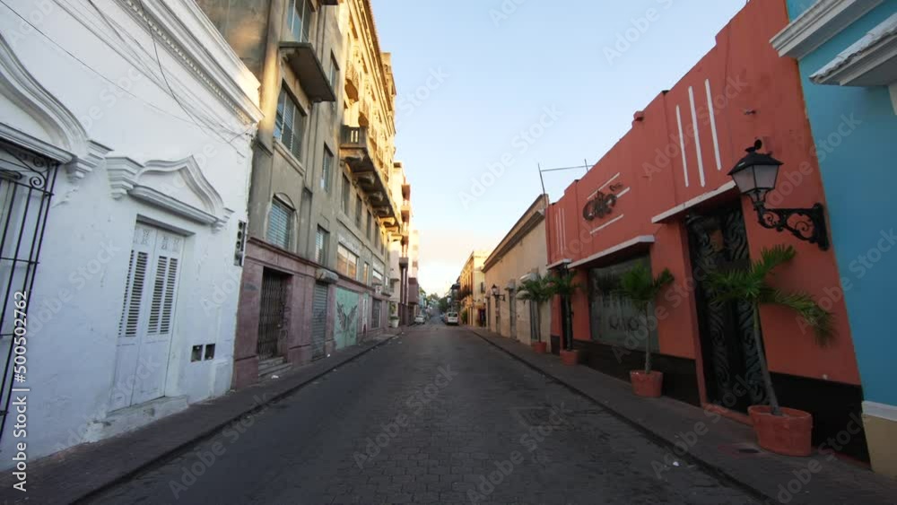 Empty street without people at sunrise in the morning in a Colonial city. Santo Domingo, Dominican Republic Empty street without people at sunrise in the morning in a Colonial city. Santo Domingo, Dominican Republic