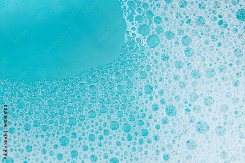 foam bubbles.Blue water with white foam bubbles.Foam Water Soap Suds. blue soap bubbles background. - obrazy, fototapety, plakaty 
