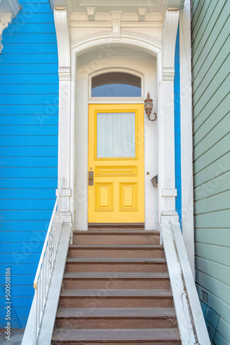 Entrance of a house with ornate columns and wooden doorsteps at San Francisco, California photo