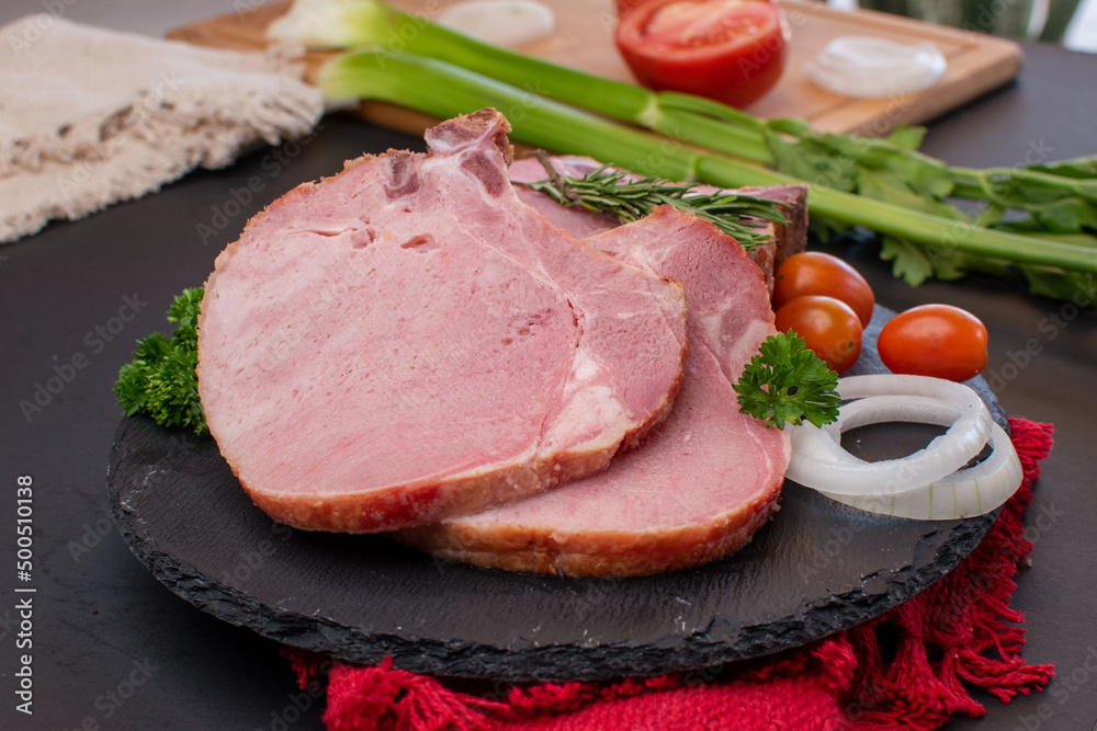 Raw pork chop with vegetables on table Raw pork chop with vegetables on table