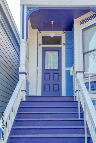 Violet entrance exterior of a house with white trims and railings at San Francisco, California