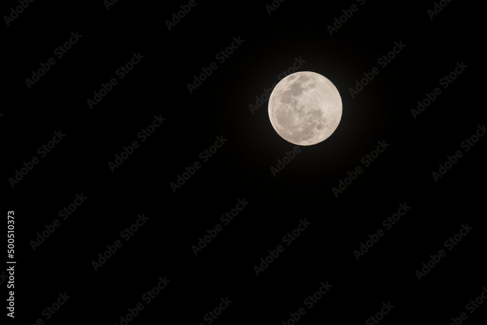 Close up yellow full moon on the Black sky Close up yellow full moon on the Black sky