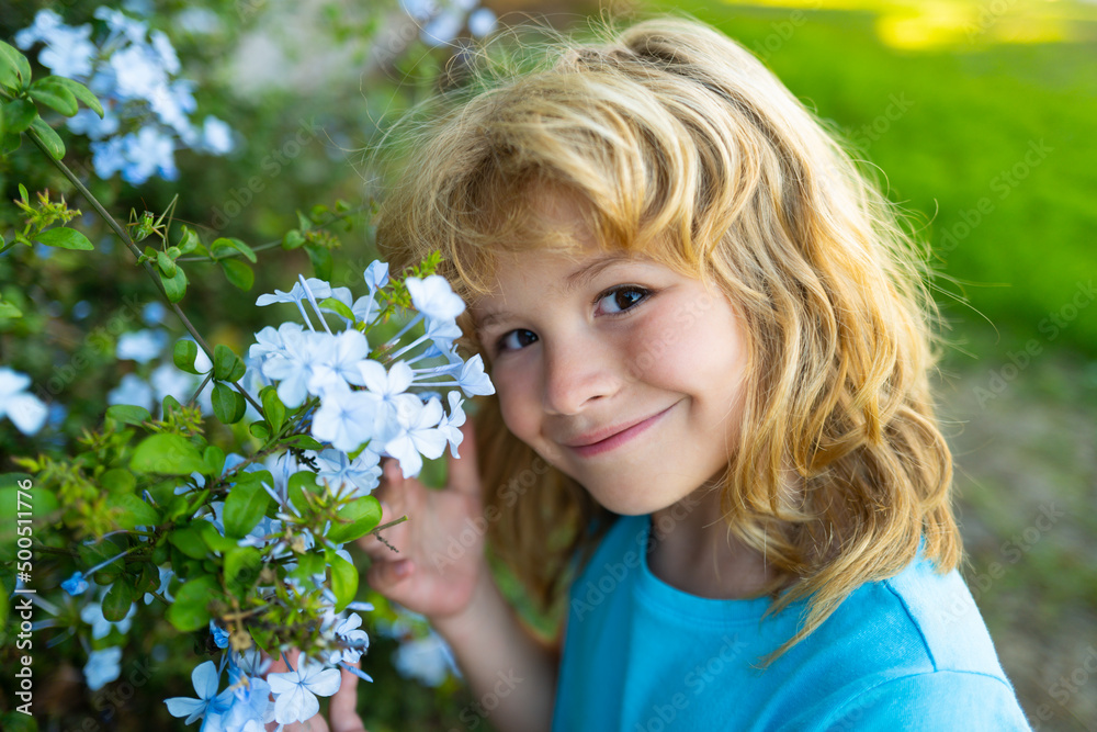 Portrait of beautiful child in the summer blossoming garden. Happy kid on the meadow with white flowers. Warm summer evening. Kids and nature. Portrait of beautiful child in the summer blossoming garden. Happy kid on the meadow with white flowers. Warm summer evening. Kids and nature.