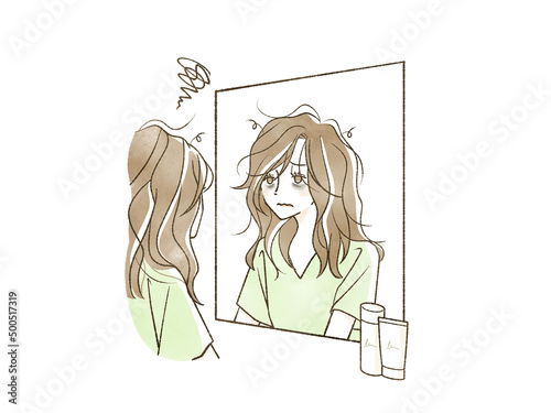 鏡を見ている髪の毛がボサボサの女性
