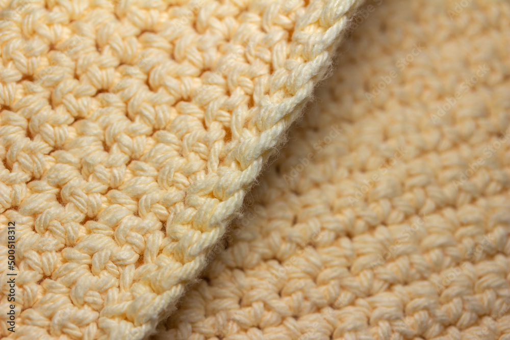 Close up abstract background of single crochet stitch elegant fabric composed of buttery white popcorn texture yarn Close up abstract background of single crochet stitch elegant fabric composed of buttery white popcorn texture yarn