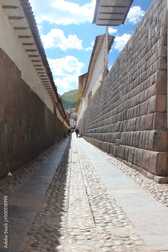 Rua estreita de Cusco com muros contruidos com vestígios incas e colonização espanhola photo