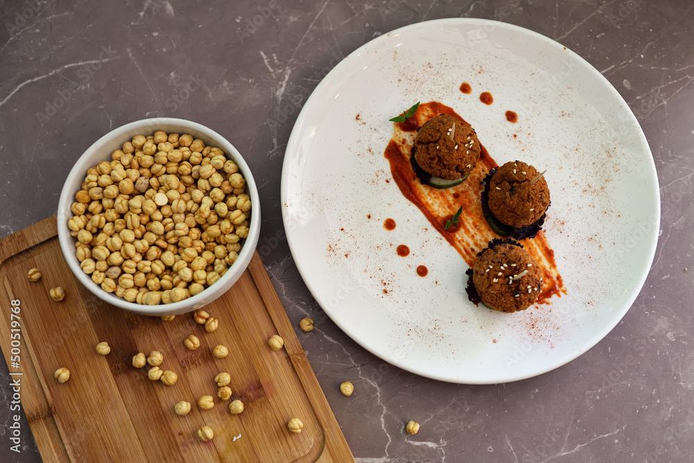 Roasted vegan chickpeas meatballs in tomato sauce. Roasted vegan chickpeas meatballs in tomato sauce.