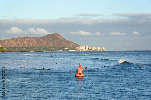 Obraz na plátne Surfers at sunset at Ala Moana Beach Park near Kewalo Harbor in Honolulu Hawaii