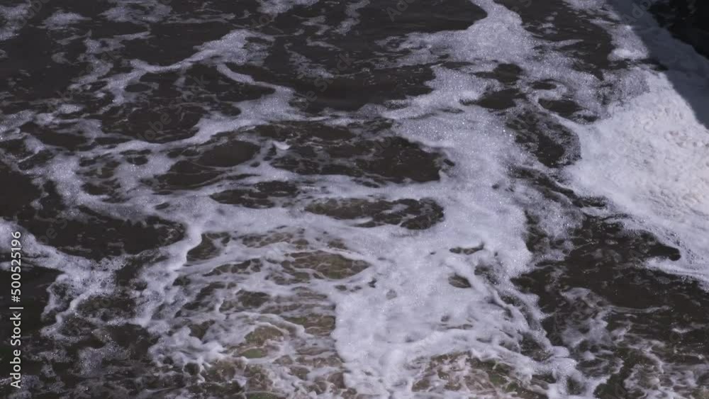 A turbulent stream of water view from above. Discharge of water from the reservoir in the spring.
