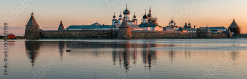 Panoramic view of the Spaso-Preobrazhensky Solovetsky Monastery from the side of the Holy Lake on a sunny cloudless morning, Solovetsky Island, Arkhangelsk region, Russia
