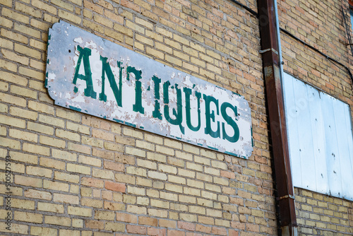 A well-weathered sign reading 