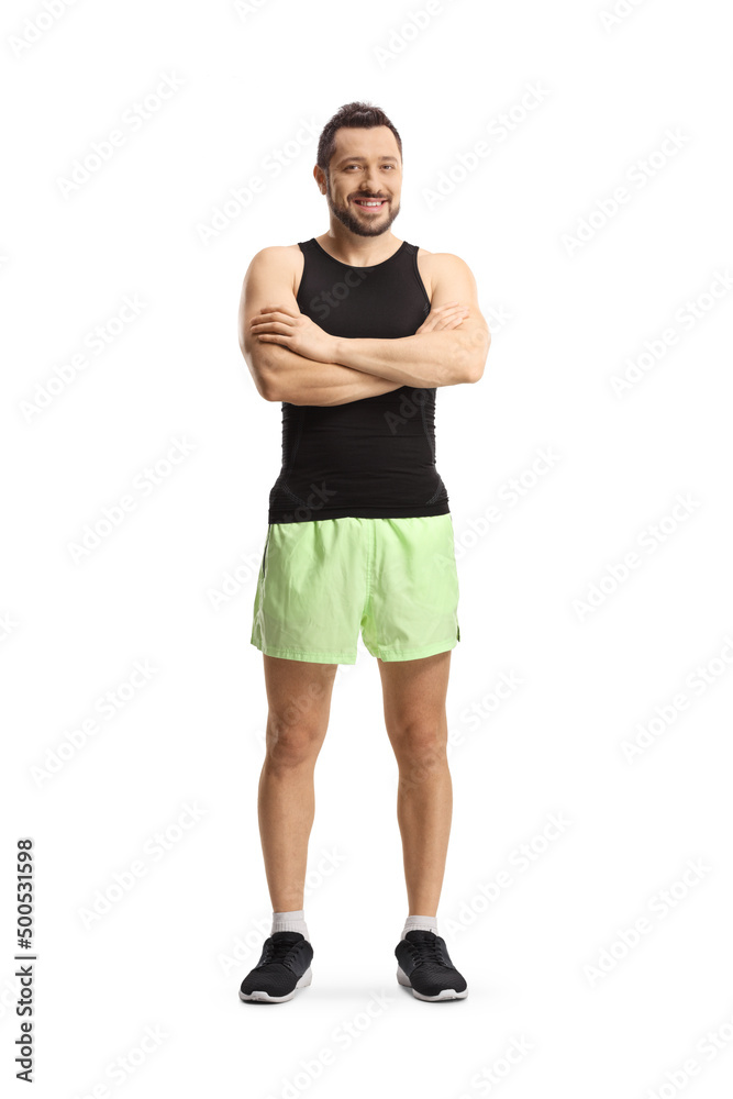 Full length portrait of a young man in sportswear posing and looking at camera Full length portrait of a young man in sportswear posing and looking at camera