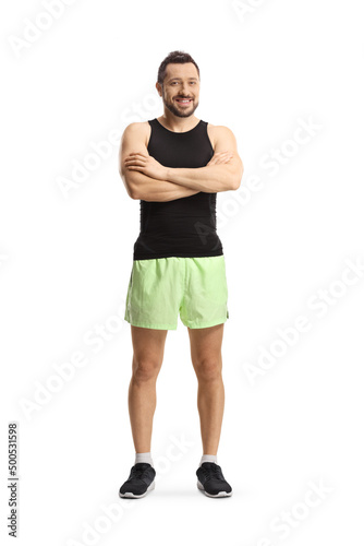 Full length portrait of a young man in sportswear posing and looking at camera