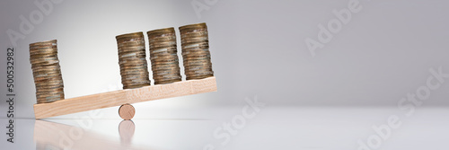 Konstfotografi Stack Of Coins On Wooden Seesaw