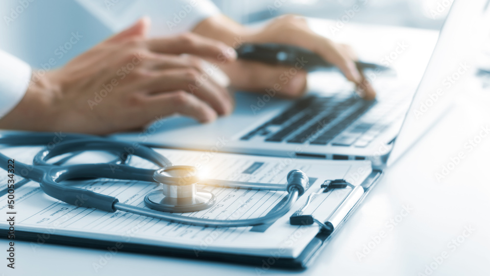the doctor analyzes the medical report Thorough physical examination, patient data recording with laptop computers. the doctor analyzes the medical report Thorough physical examination, patient data recording with laptop computers.