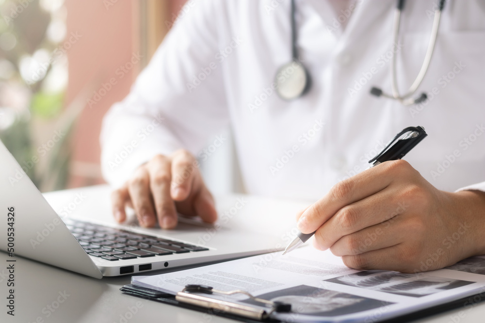 the doctor analyzes the medical report Thorough physical examination by x-ray, patient data recording with laptop computers. the doctor analyzes the medical report Thorough physical examination by x-ray, patient data recording with laptop computers.