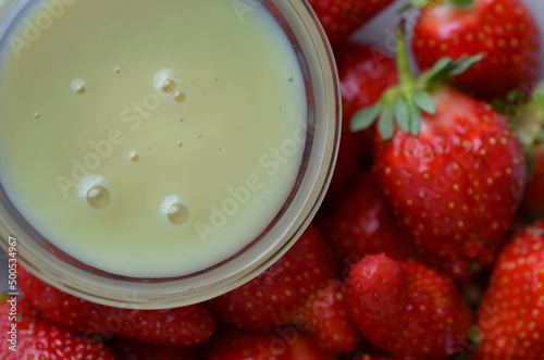 Ripe juicy strawberries with condensed milk