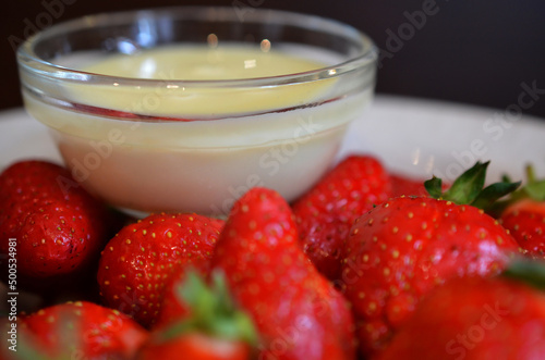 Ripe juicy strawberries with condensed milk