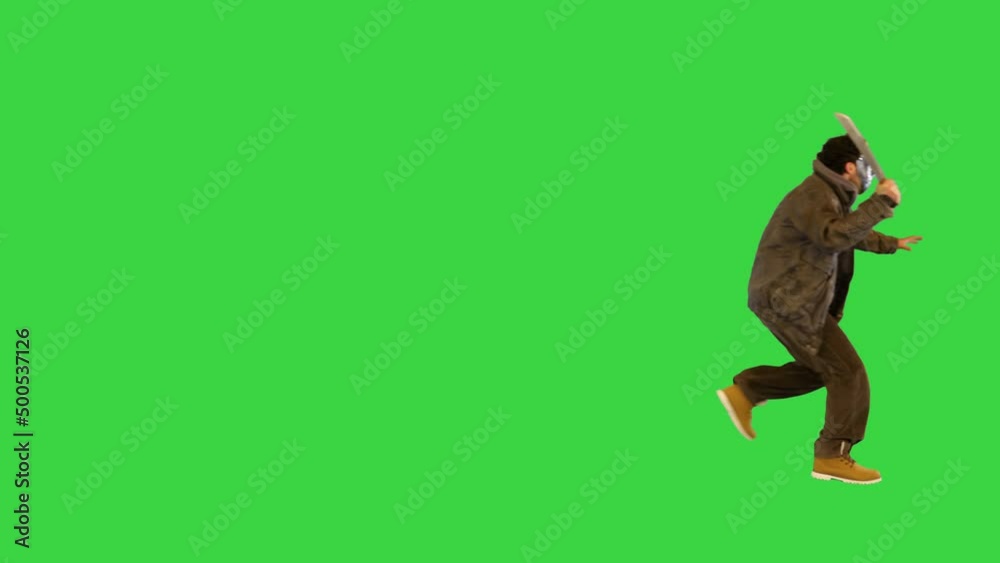 Crazy maniac in scary mask sneaking follow victim holding big knife Dangerous murderer running on a Green Screen, Chroma Key. Crazy maniac in scary mask sneaking follow victim holding big knife Dangerous murderer running on a Green Screen, Chroma Key.