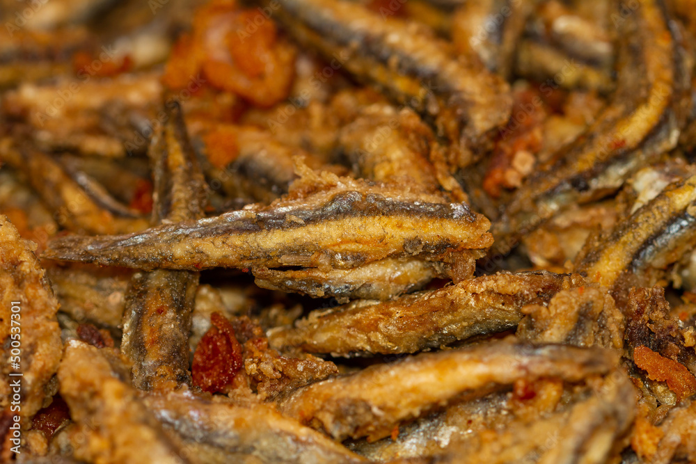 Close-up of fried and battered anchovies in a market in Malaga (Spain), gastronomy of Spain, selective focus on the center of the image.