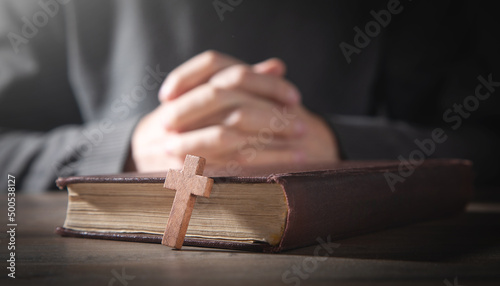 Human praying with Bible. Religion